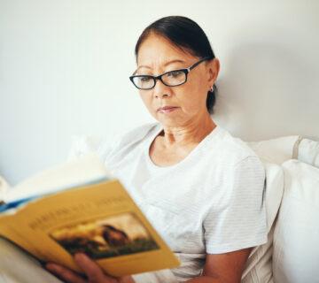 Senior woman reading in bed.